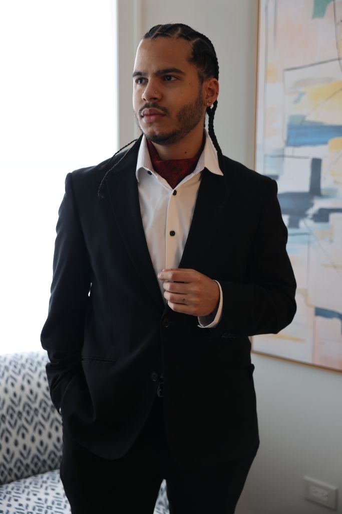 Joshua H. Jimenez wearing a black suit and white dress shirt.
